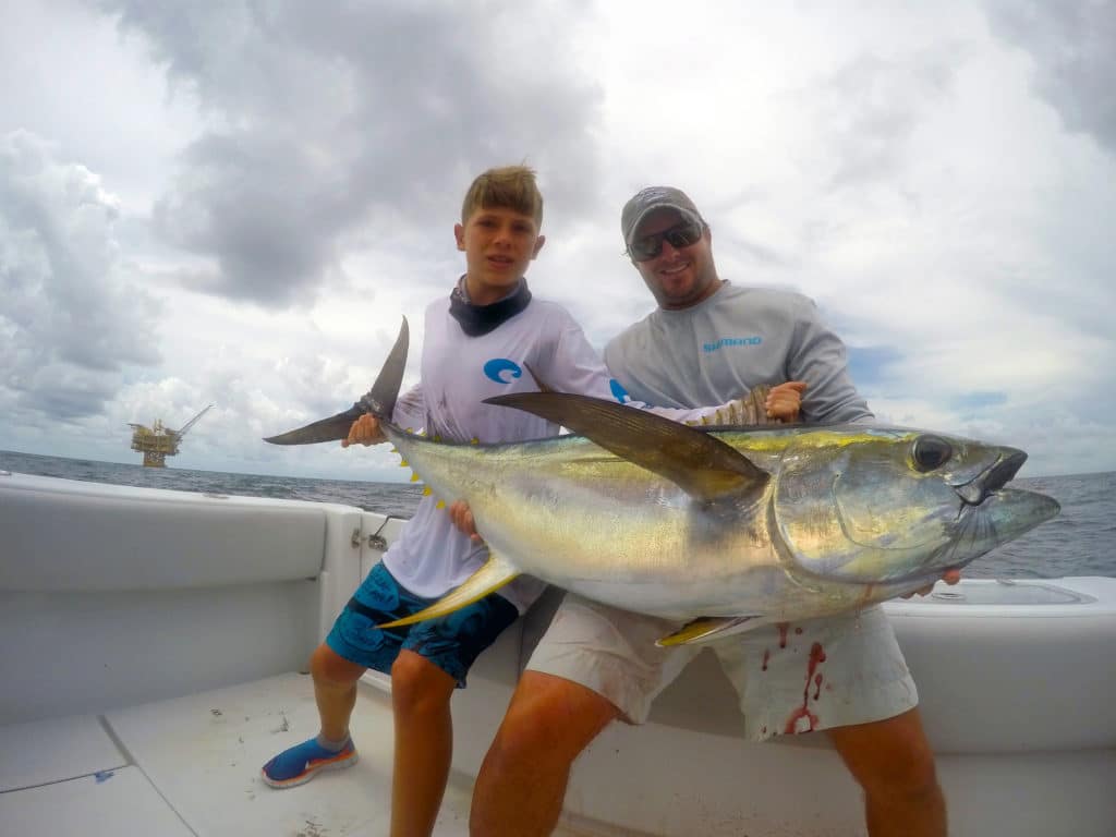 Fishermen holding a tuna fish they caught