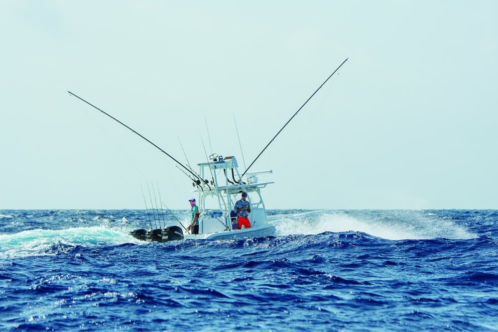 A center console boat trolls in very rough seas