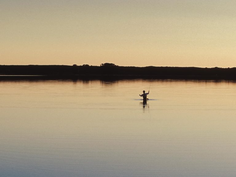 Angler fishing at sunrise