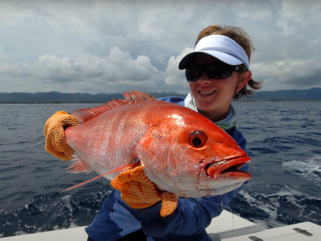 Women angler holding up a fish